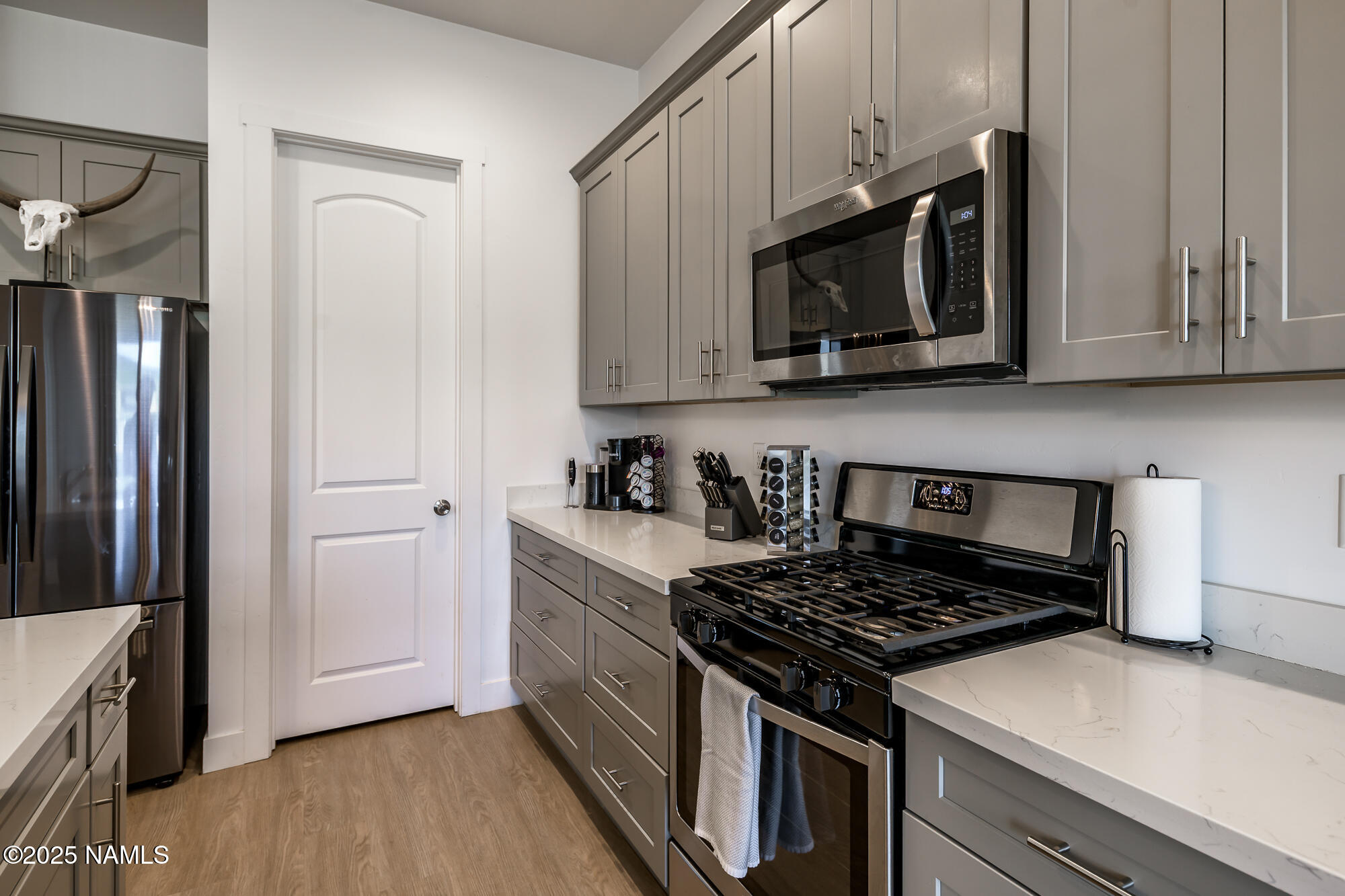 11780 Pegasus Road Bellemont, AZ 86015 - Photo 18 of 44 a kitchen with stainless steel appliances granite countertop a stove and a refrigerator