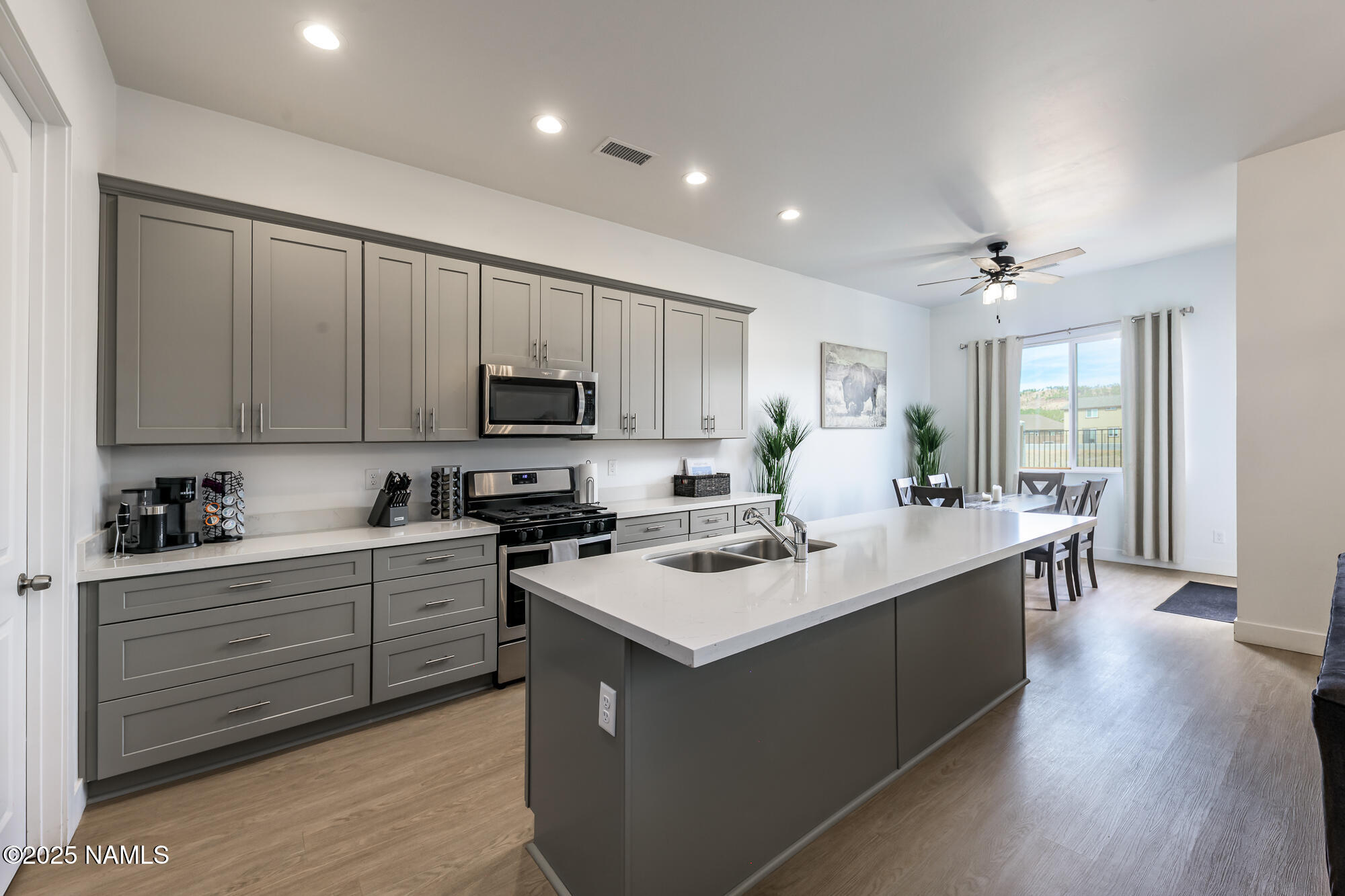 11780 Pegasus Road Bellemont, AZ 86015 - Photo 20 of 44 a kitchen with a sink stove and cabinets