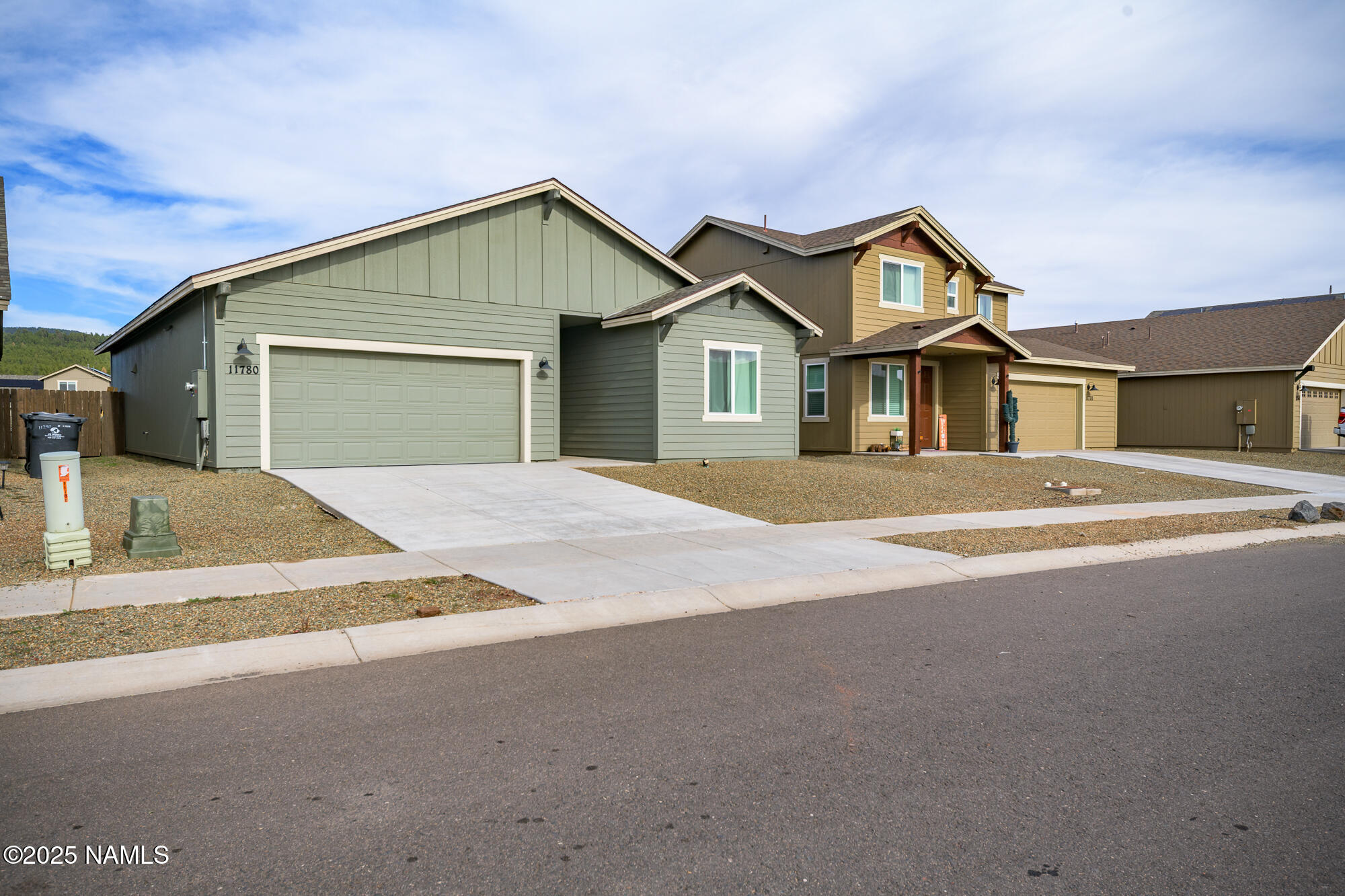 11780 Pegasus Road Bellemont, AZ 86015 - Photo 2 of 44 a front view of a house with a yard and garage