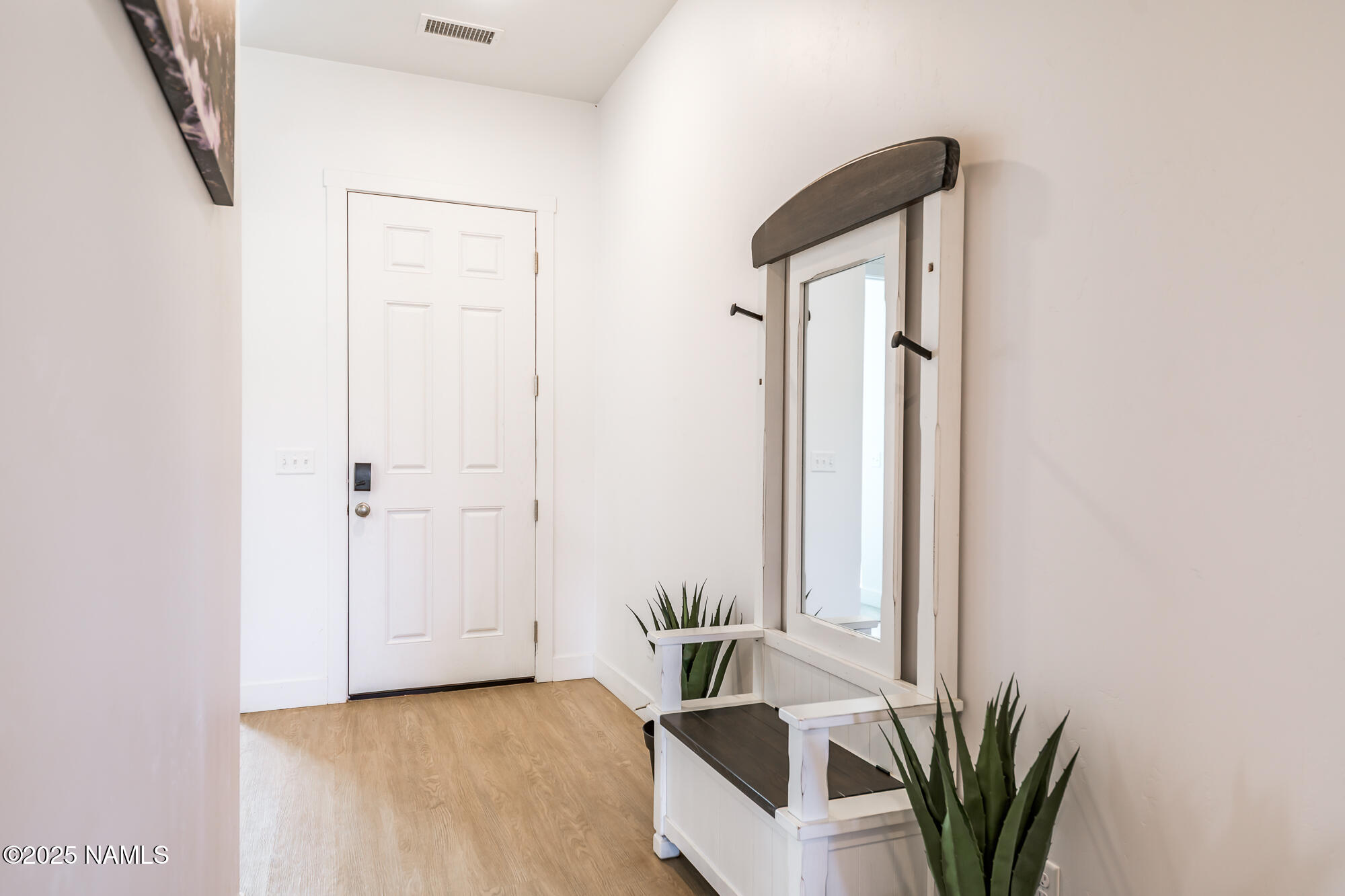11780 Pegasus Road Bellemont, AZ 86015 - Photo 27 of 44 a view of a hallway with a potted plant