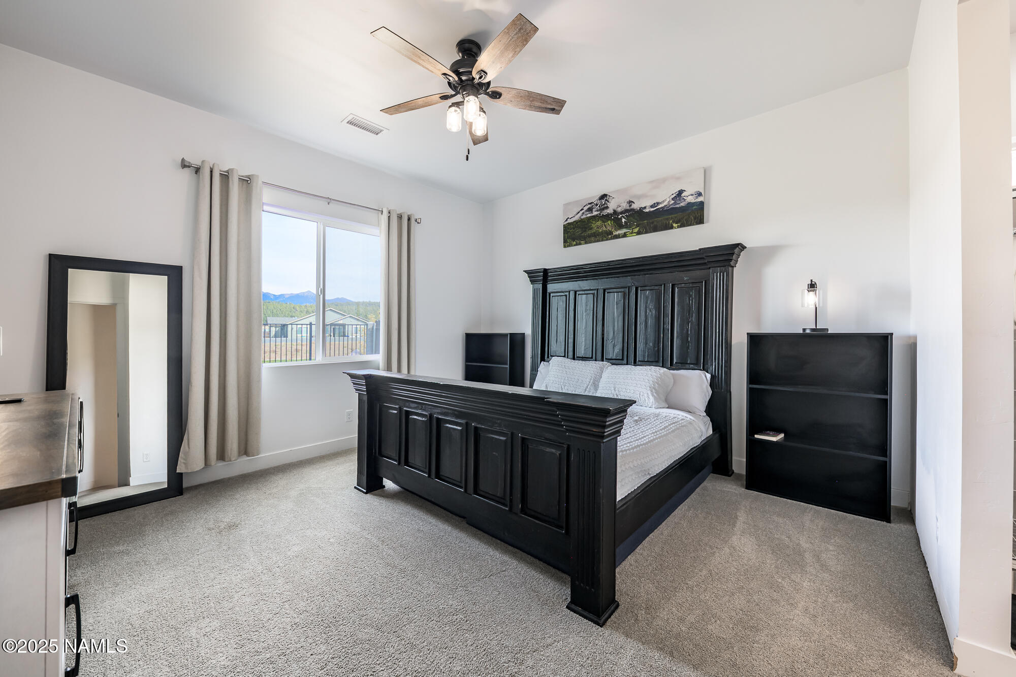 11780 Pegasus Road Bellemont, AZ 86015 - Photo 29 of 44 a bed room with a bed and a window