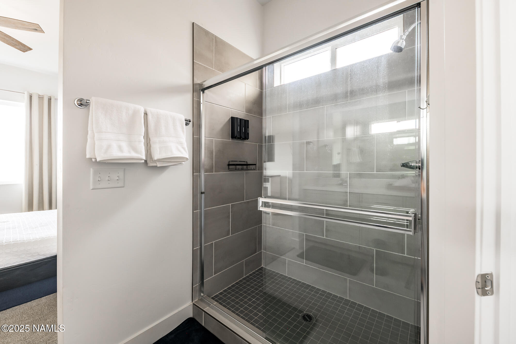 11780 Pegasus Road Bellemont, AZ 86015 - Photo 35 of 44 a bathroom with a glass shower door