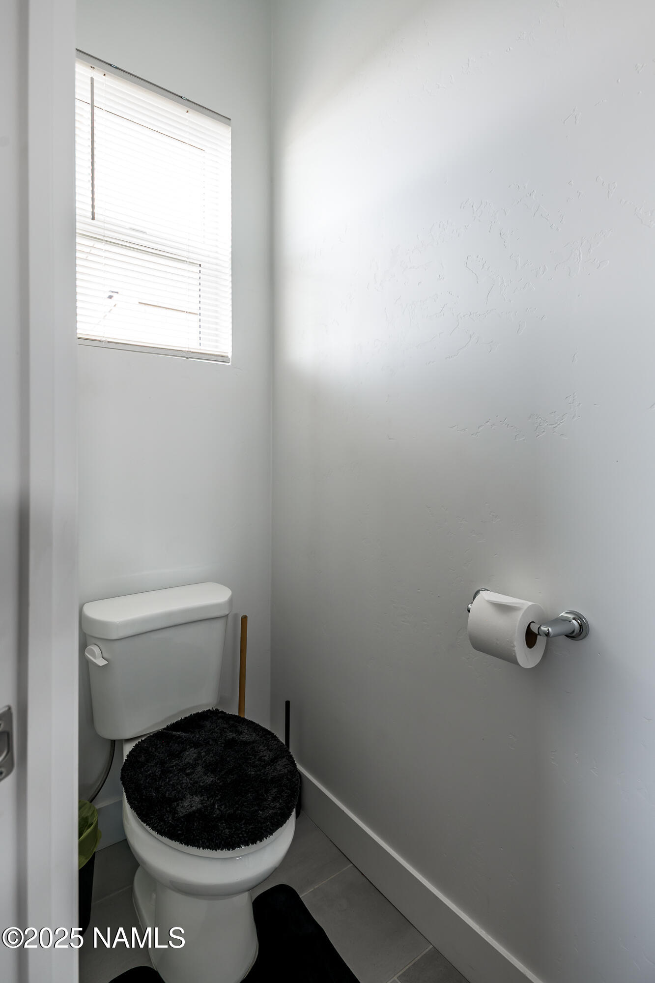 11780 Pegasus Road Bellemont, AZ 86015 - Photo 37 of 44 a bathroom with a toilet and a window