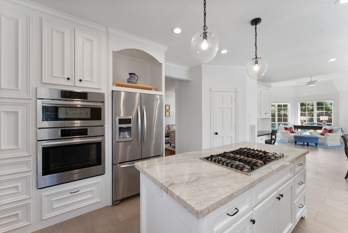 5503 Winding Ridge Drive Spring, TX 77379 - Photo 15 of 50 The large island with gas cooktop, abundance of cabinet space, large walk-in pantry and more will impress the chef of the home.