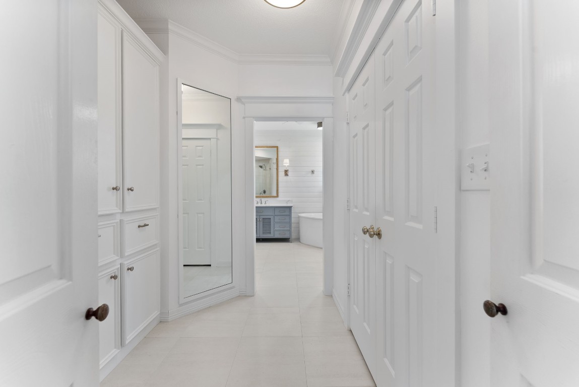 5503 Winding Ridge Drive Spring, TX 77379 - Photo 23 of 50 Fashion crafted hallway leading from the primary bedroom to the primary bathroom with one of two walk-in closets and a full length mirror to put together the perfect outfit for the day.