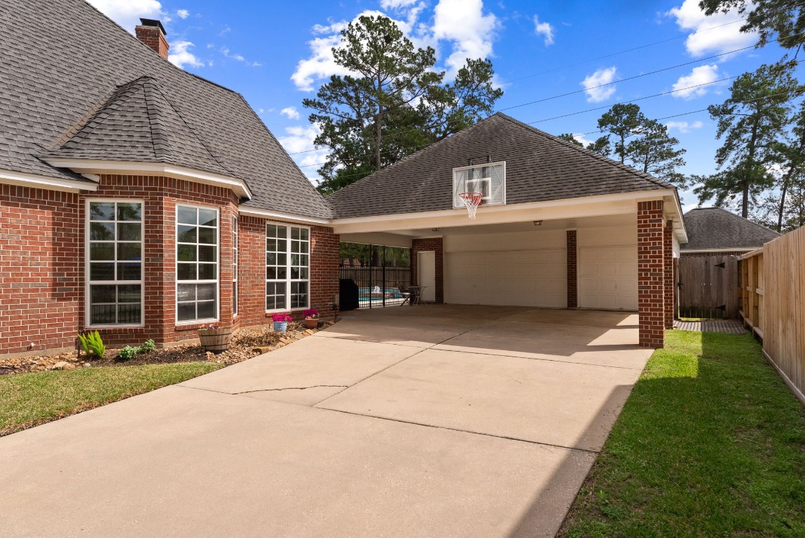 5503 Winding Ridge Drive Spring, TX 77379 - Photo 44 of 50 Extra parking, extra covered entertaining space, and just a great driveway overall with an automated driveway gate for extra security/privacy.