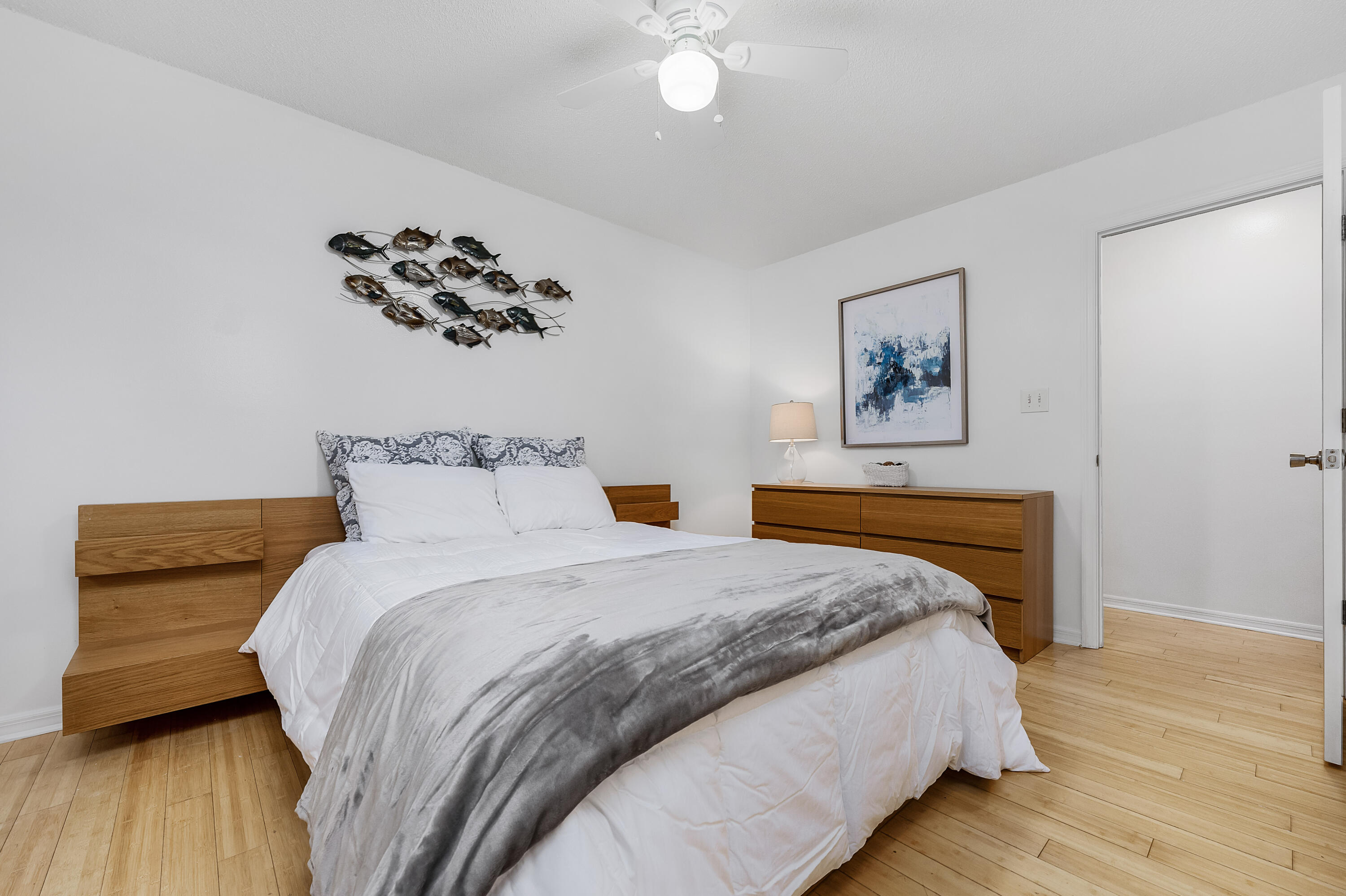 1006 E Highway, Unit 212 Destin, FL 32541 - Photo 15 of 52 a bedroom with a large bed and a chandelier