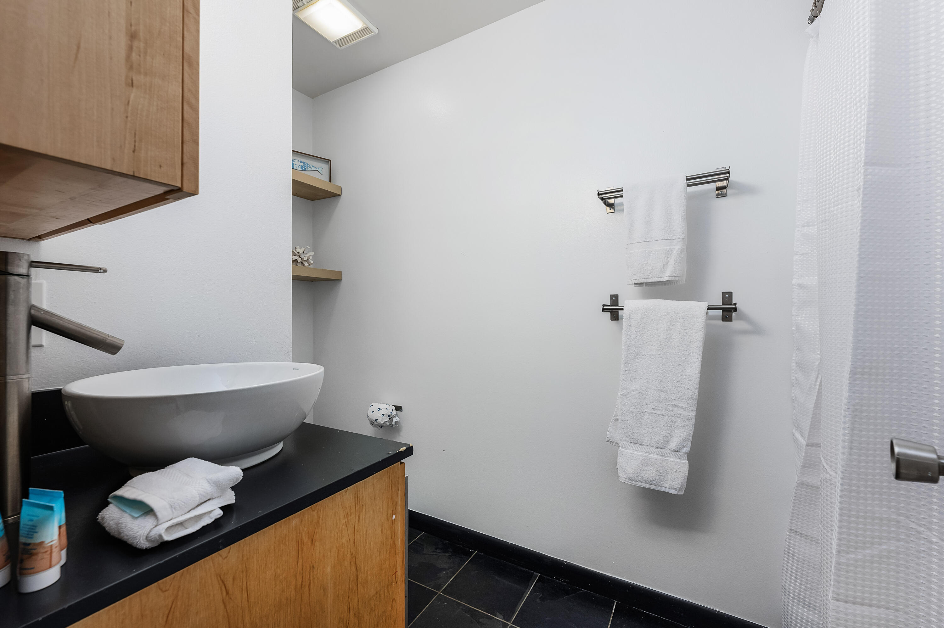 1006 E Highway, Unit 212 Destin, FL 32541 - Photo 16 of 52 a white toilet sitting next to a bathroom sink