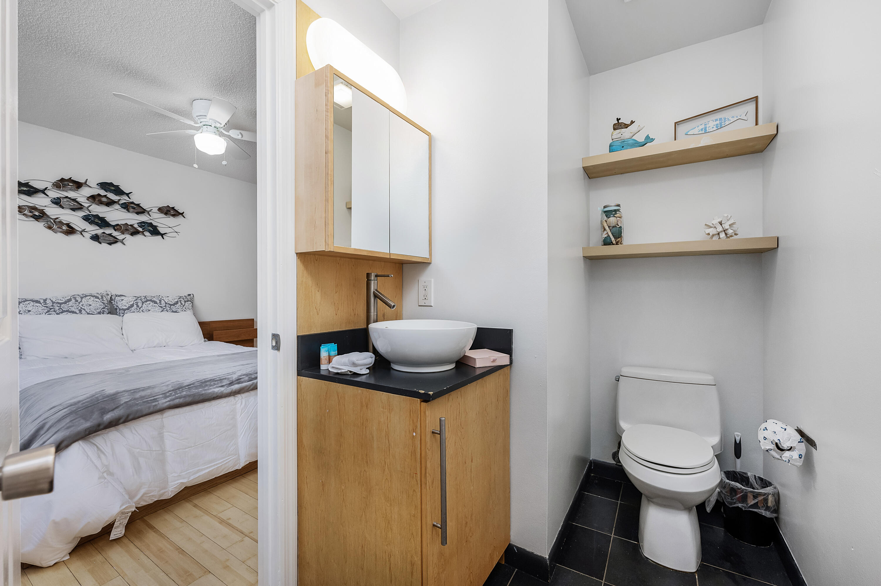 1006 E Highway, Unit 212 Destin, FL 32541 - Photo 18 of 52 a bathroom with a toilet sink and mirror