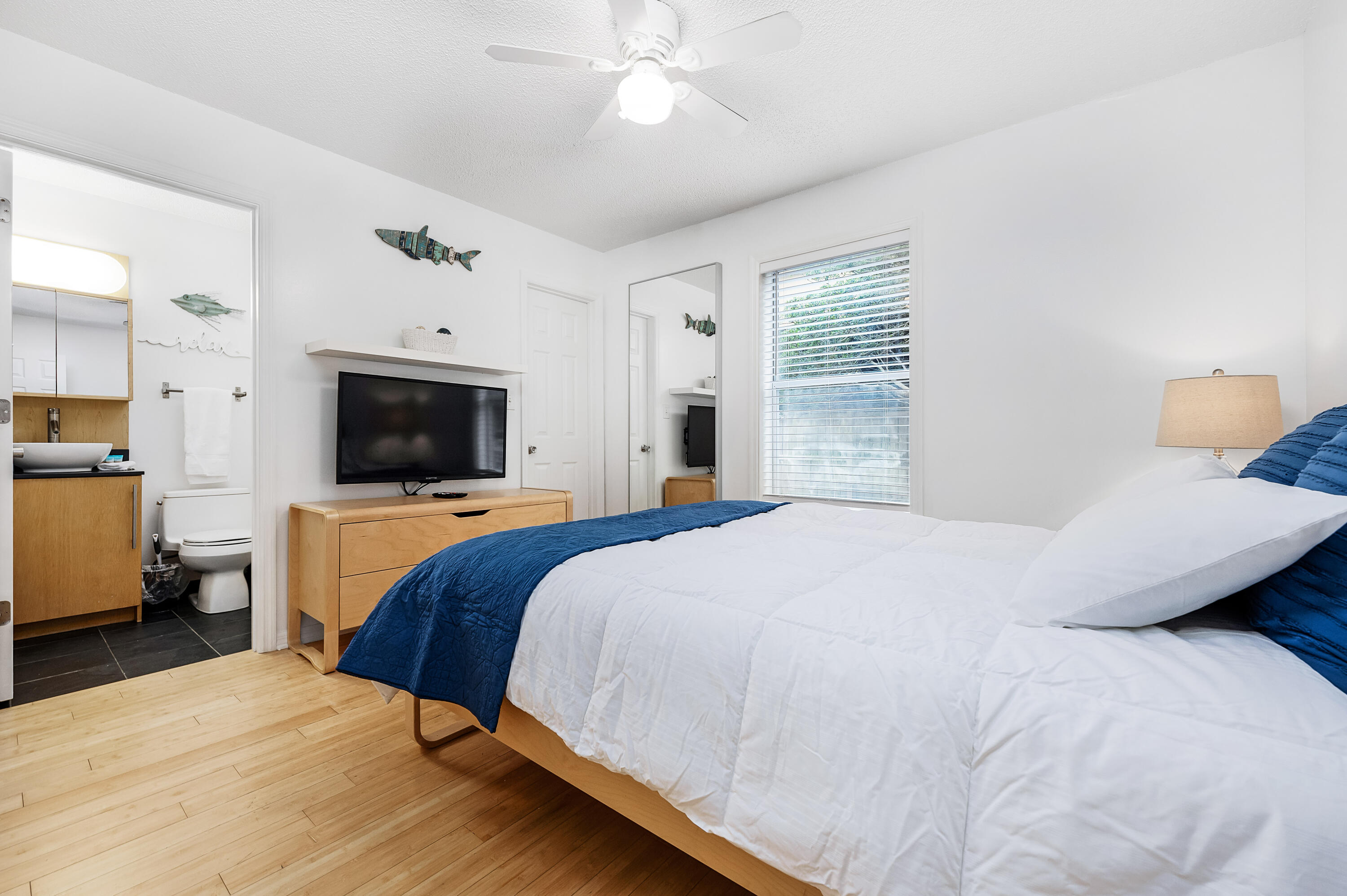 1006 E Highway, Unit 212 Destin, FL 32541 - Photo 20 of 52 a bedroom with a bed and a television