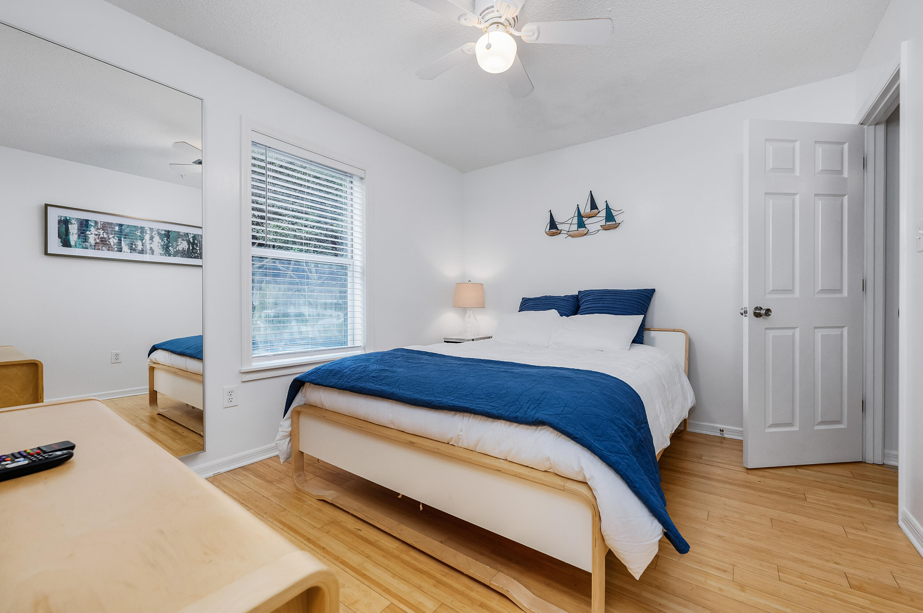 1006 E Highway, Unit 212 Destin, FL 32541 - Photo 21 of 52 a bedroom with a bed and a chandelier