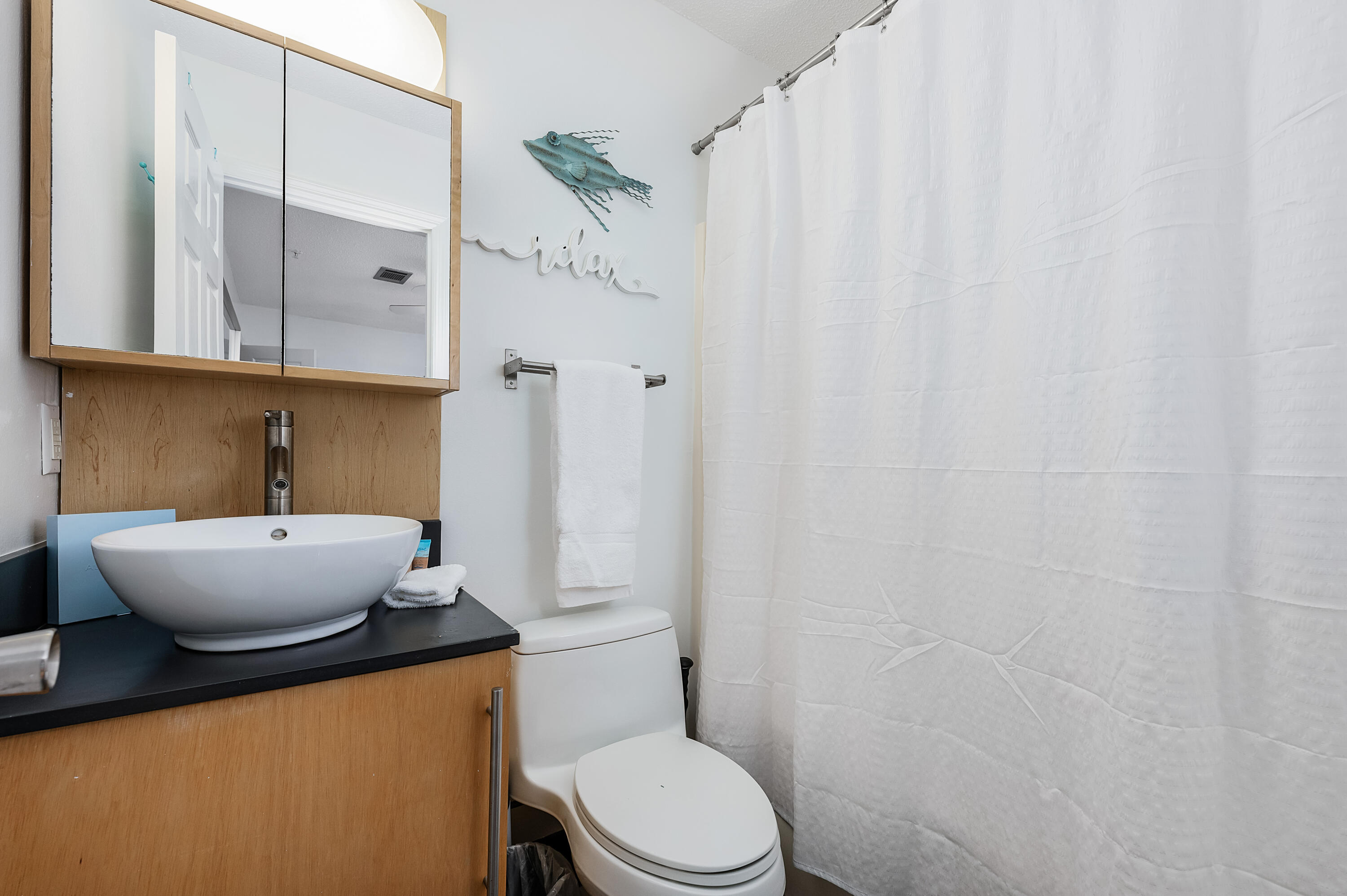 1006 E Highway, Unit 212 Destin, FL 32541 - Photo 24 of 52 a bathroom with a granite countertop sink and a mirror