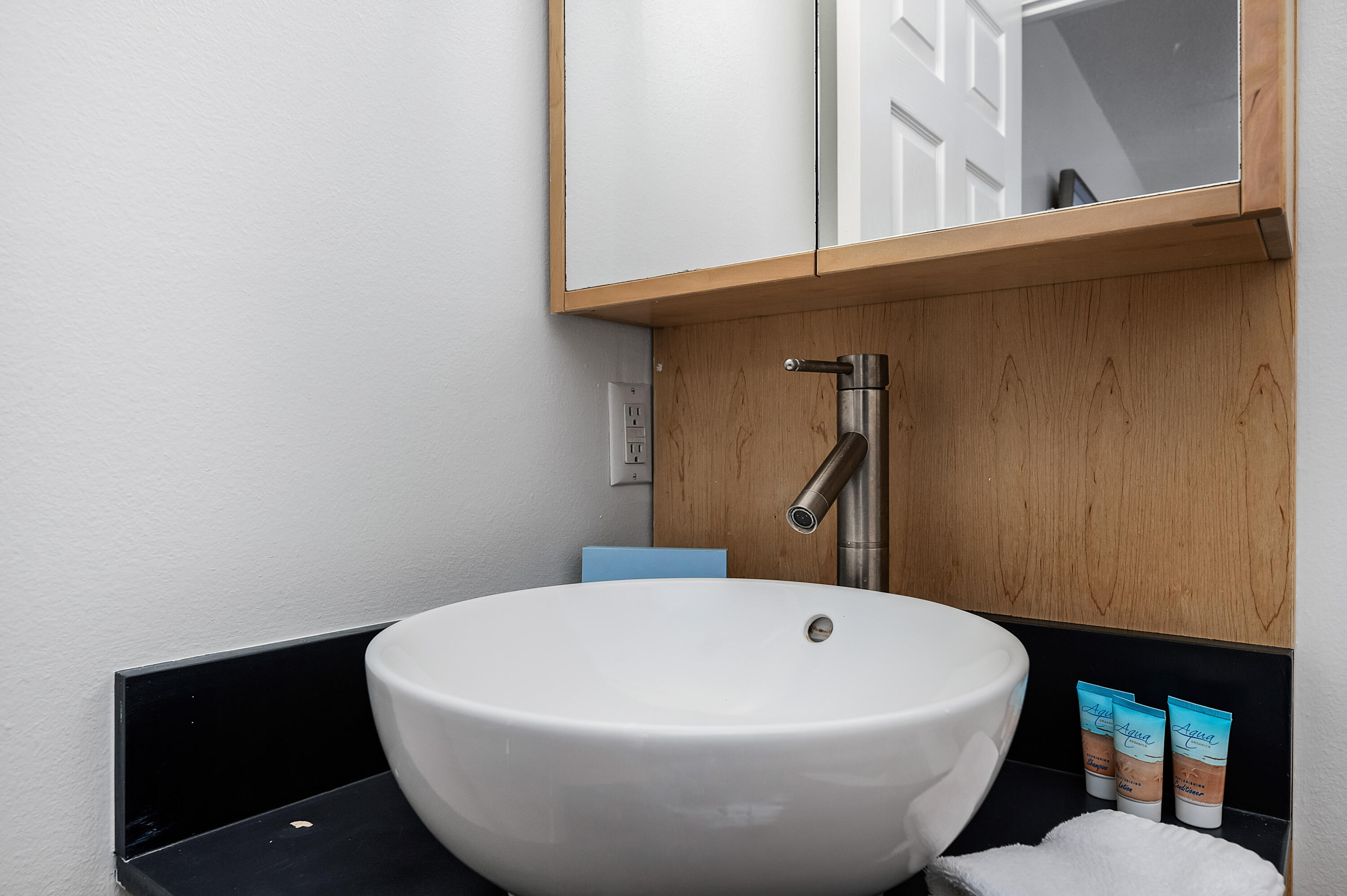 1006 E Highway, Unit 212 Destin, FL 32541 - Photo 25 of 52 a white bath tub sitting next to a blue wall