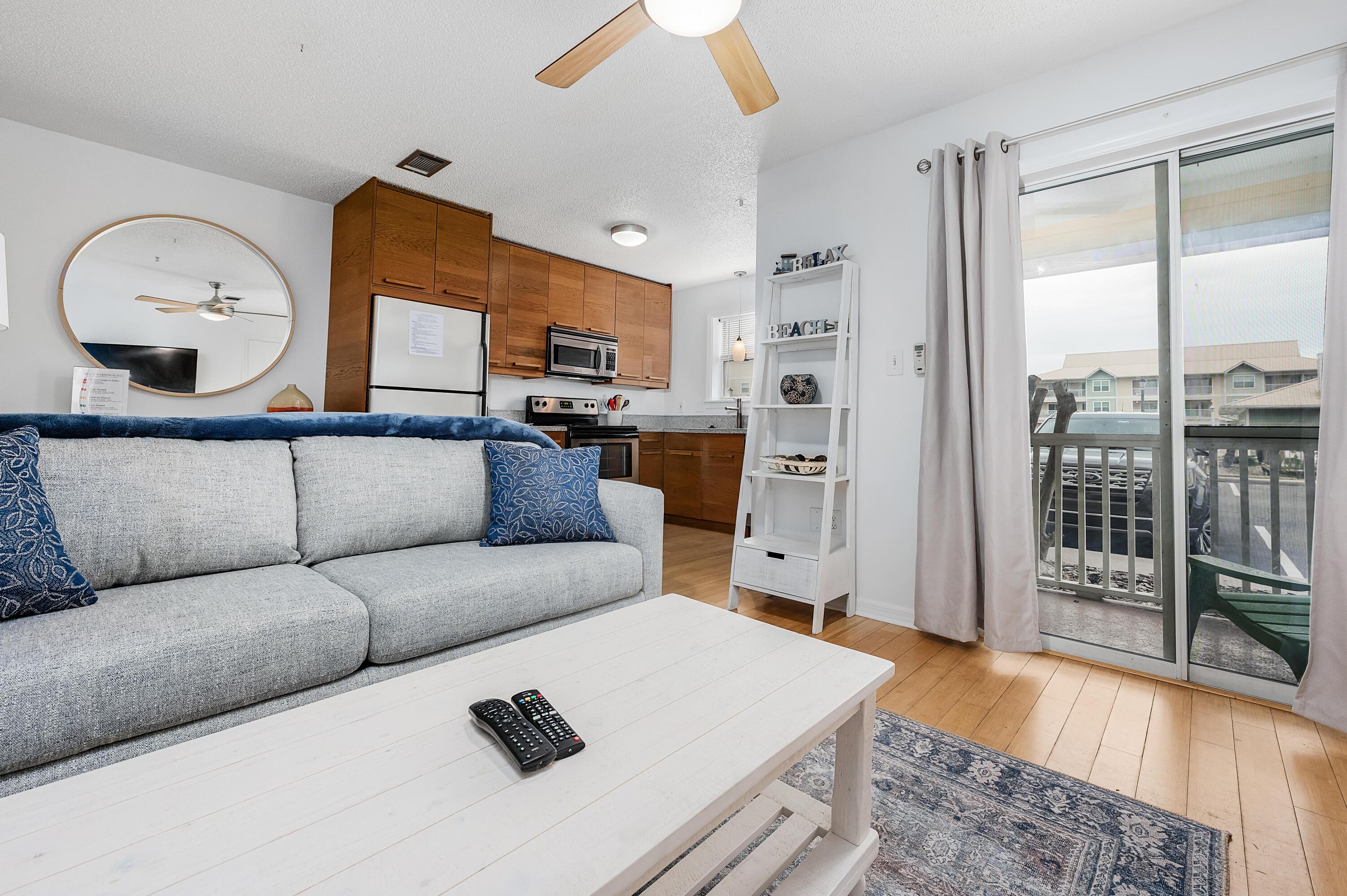1006 E Highway, Unit 212 Destin, FL 32541 - Photo 4 of 52 a living room with furniture and a fireplace
