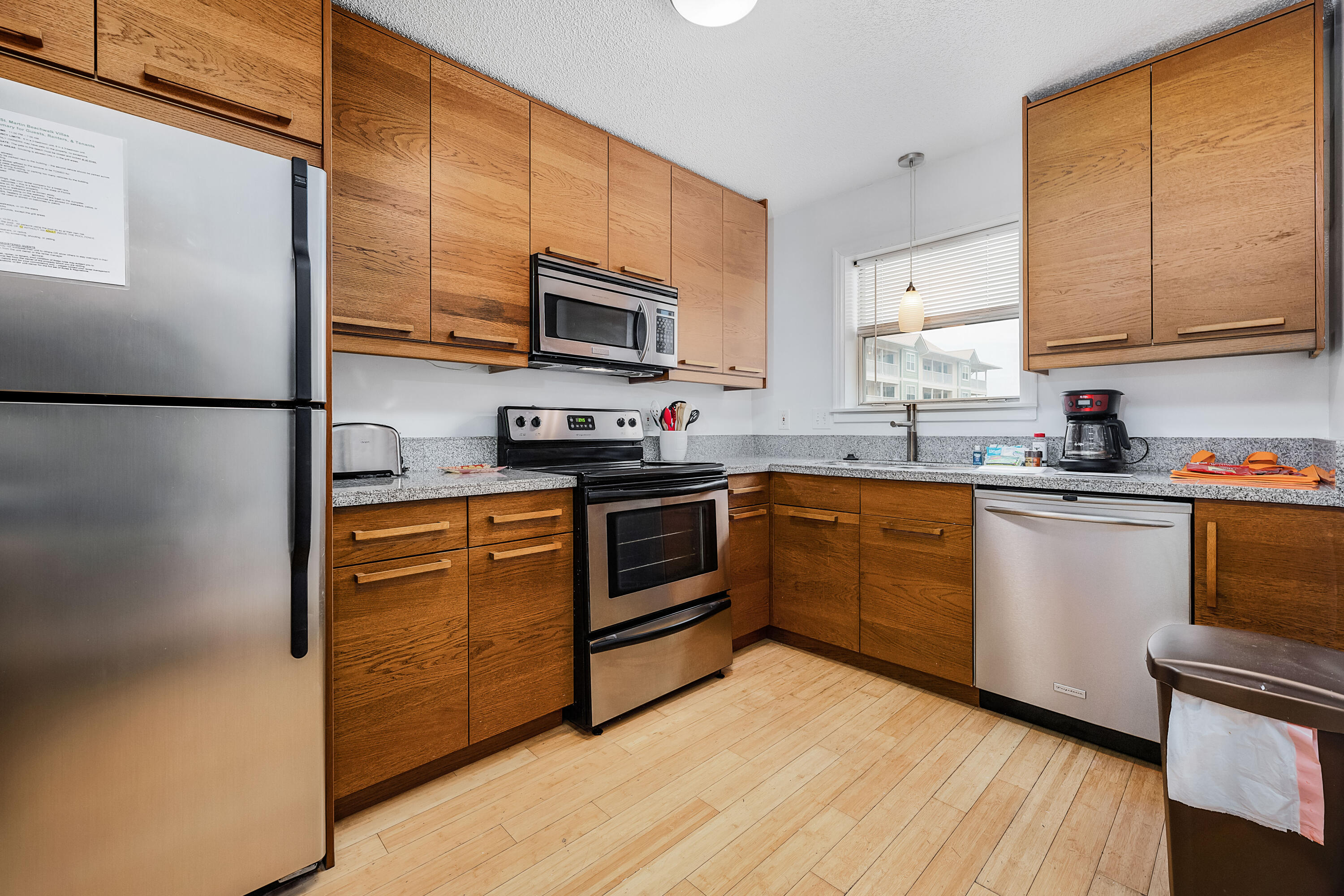 1006 E Highway, Unit 212 Destin, FL 32541 - Photo 5 of 52 a kitchen with stainless steel appliances a refrigerator sink and microwave