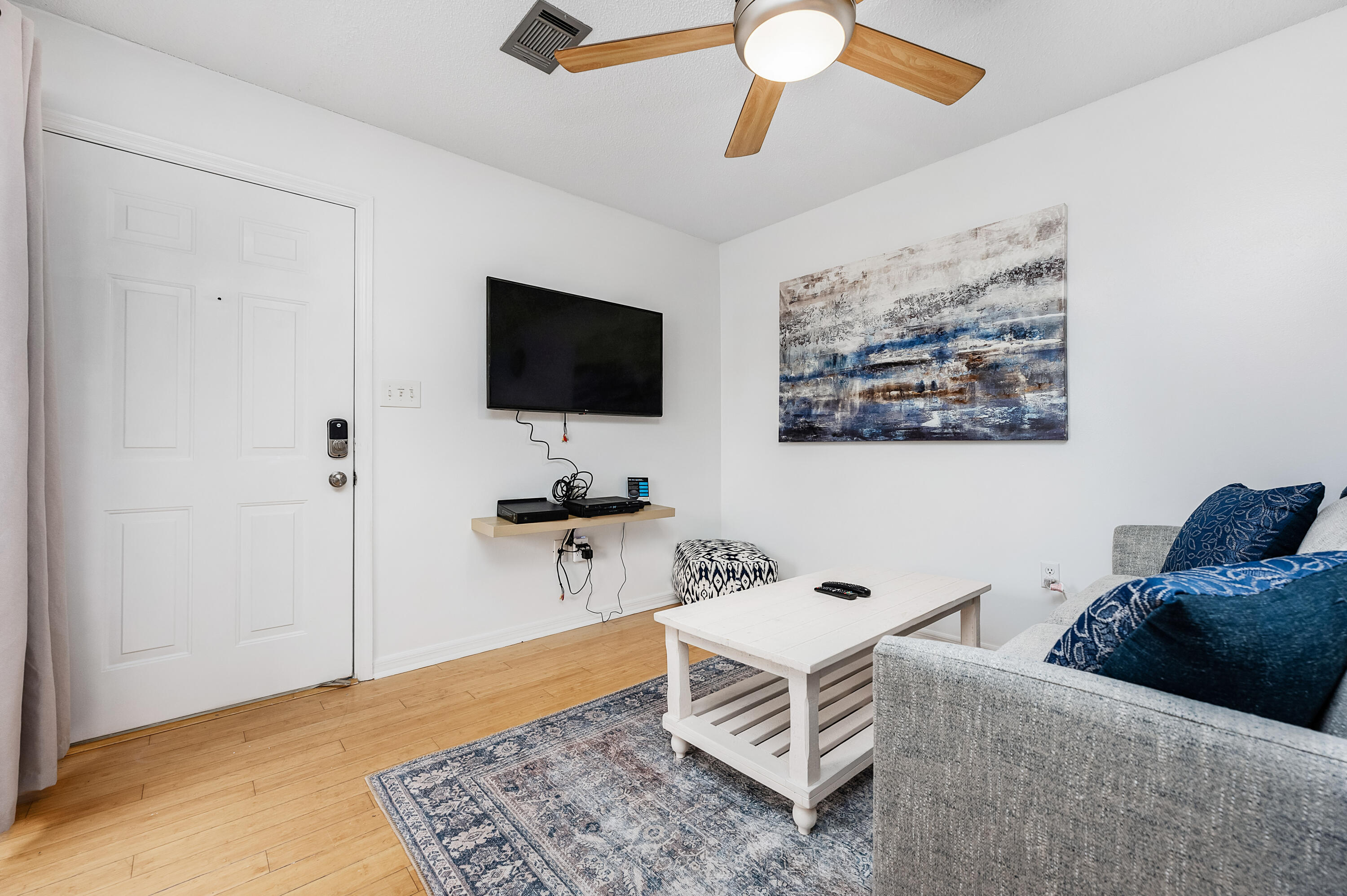 1006 E Highway, Unit 212 Destin, FL 32541 - Photo 6 of 52 a living room with furniture and a flat screen tv