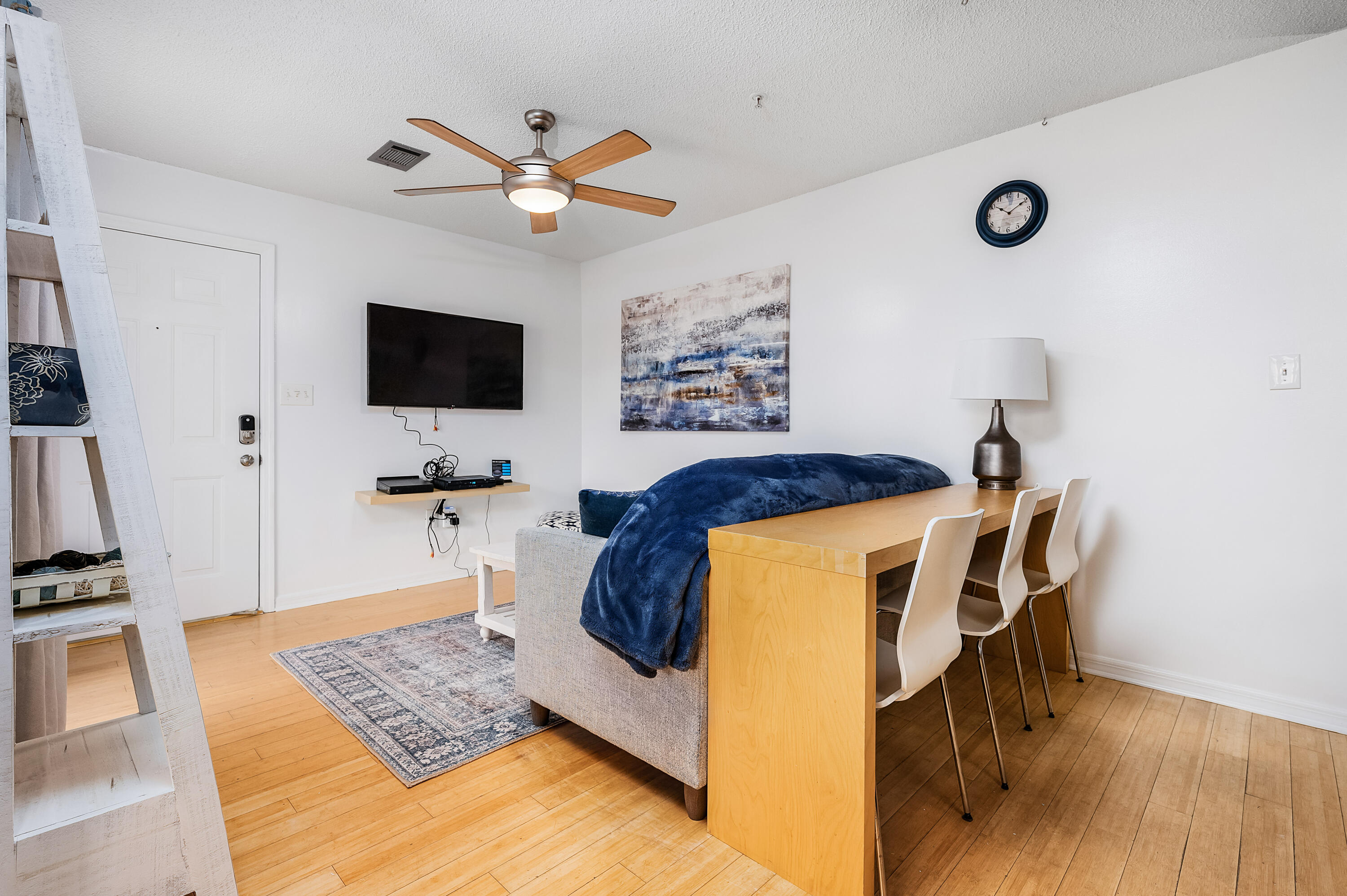 1006 E Highway, Unit 212 Destin, FL 32541 - Photo 9 of 52 a living room with furniture and a flat screen tv
