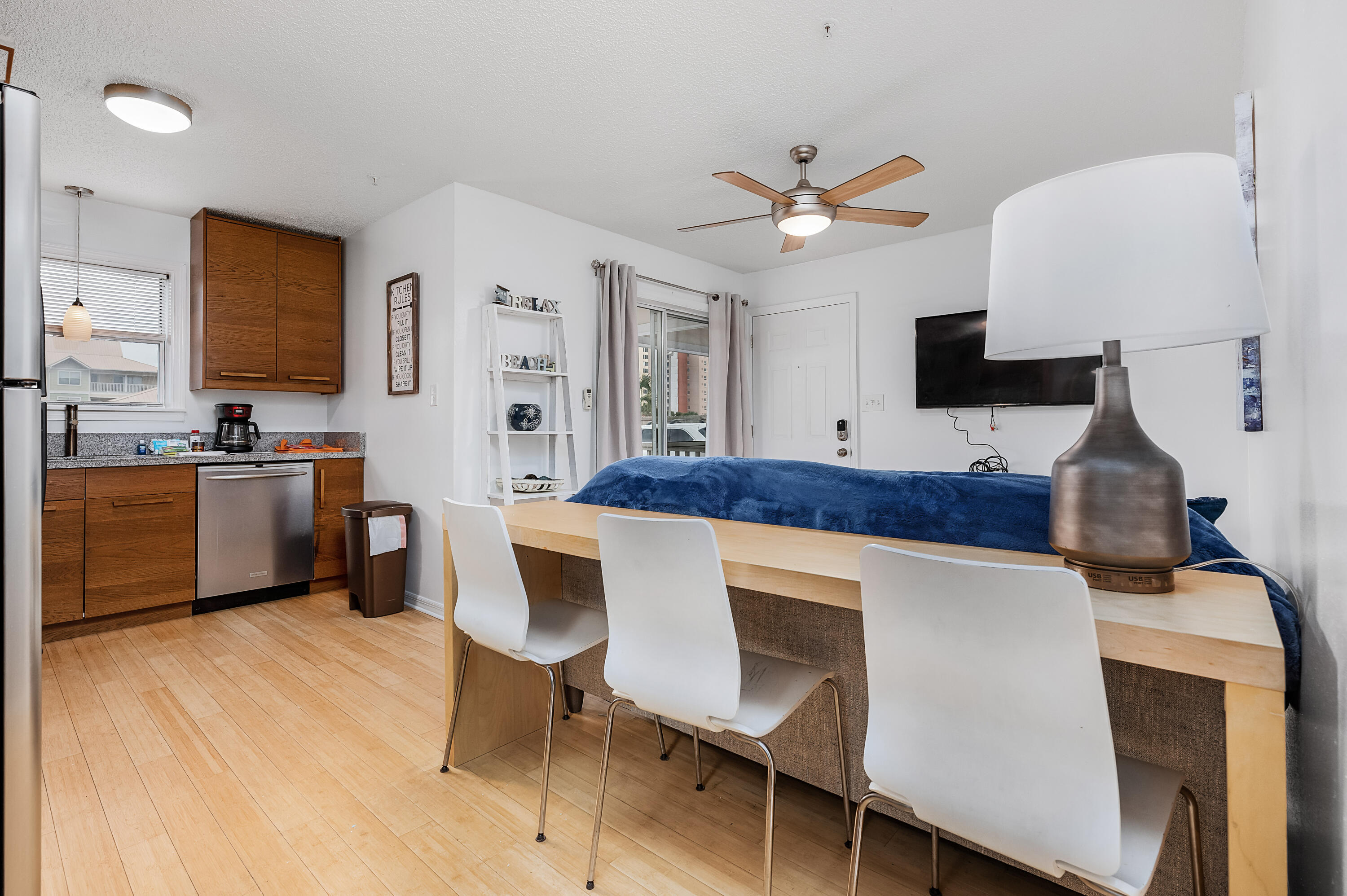 1006 E Highway, Unit 212 Destin, FL 32541 - Photo 10 of 52 a kitchen with a dining table and chairs