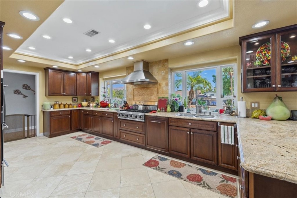 2065 Bronson Way Riverside, CA 92506 - Photo 16 of 75 a kitchen with stainless steel appliances granite countertop a sink counter space cabinets and a large window