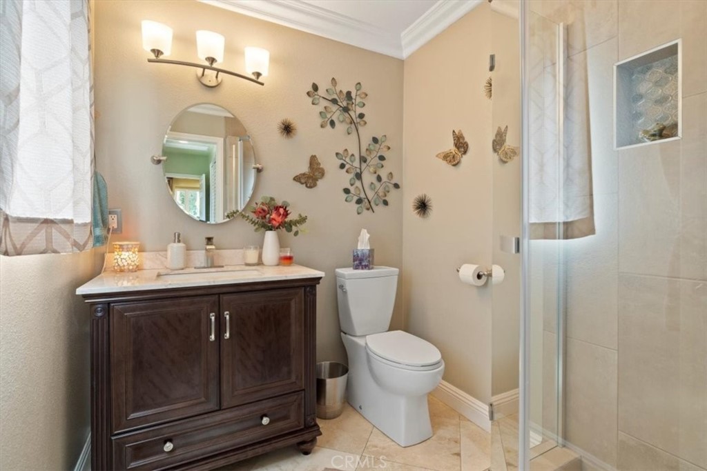 2065 Bronson Way Riverside, CA 92506 - Photo 23 of 75 a bathroom with a sink vanity mirror and toilet