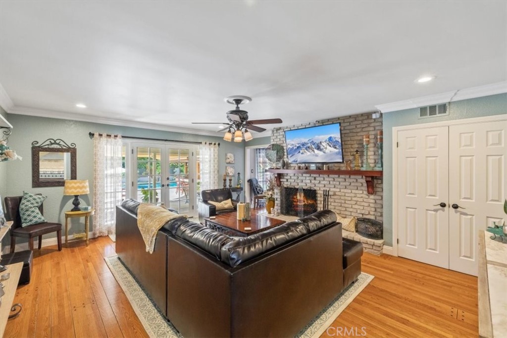 2065 Bronson Way Riverside, CA 92506 - Photo 25 of 75 a living room with fireplace furniture and a wooden floor