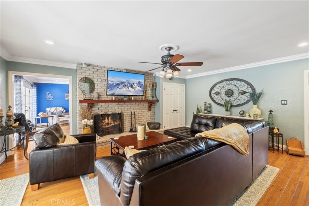 2065 Bronson Way Riverside, CA 92506 - Photo 26 of 75 a living room with furniture a fireplace and a chandelier