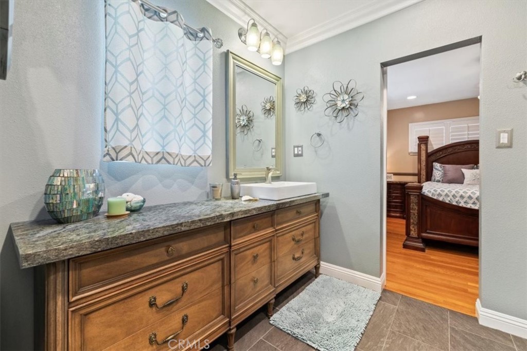 2065 Bronson Way Riverside, CA 92506 - Photo 35 of 75 a spacious bathroom with a granite countertop sink and a mirror