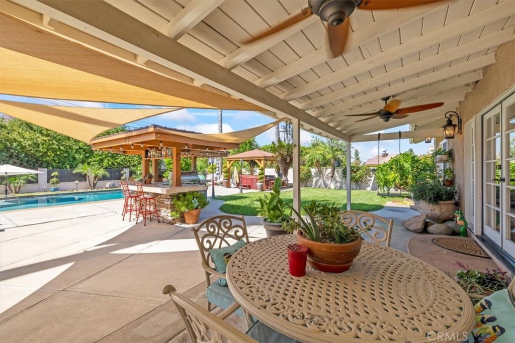 2065 Bronson Way Riverside, CA 92506 - Photo 51 of 75 a view of a patio with a dining table and chairs under an umbrella