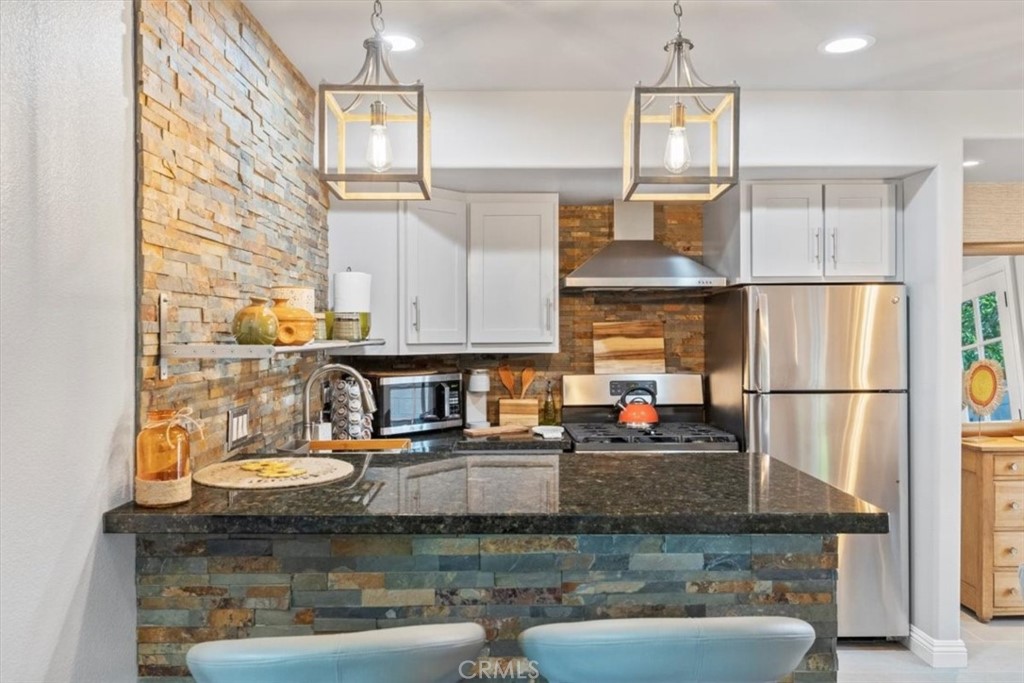 2065 Bronson Way Riverside, CA 92506 - Photo 64 of 75 a kitchen with stainless steel appliances granite countertop a sink refrigerator and cabinets