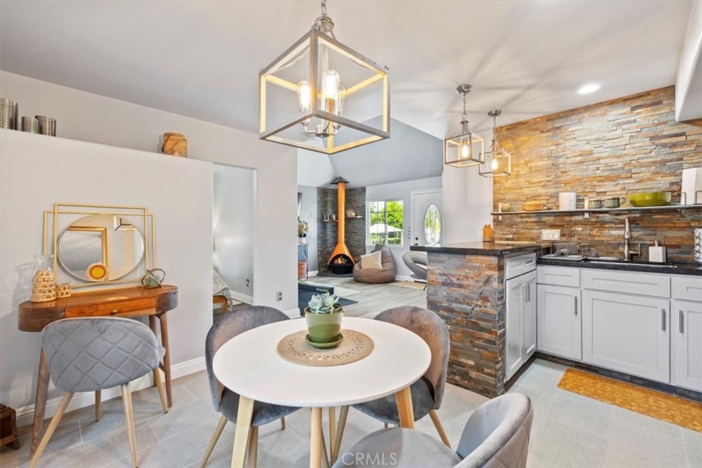 2065 Bronson Way Riverside, CA 92506 - Photo 67 of 75 a dining room with furniture a rug and wooden floor