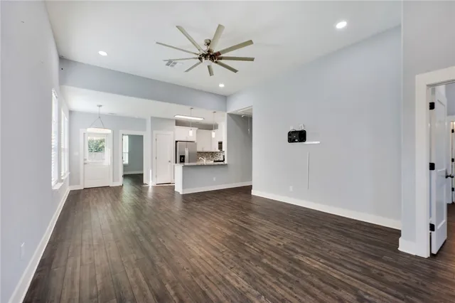 a view of a kitchen with wooden floor and a ceiling fan