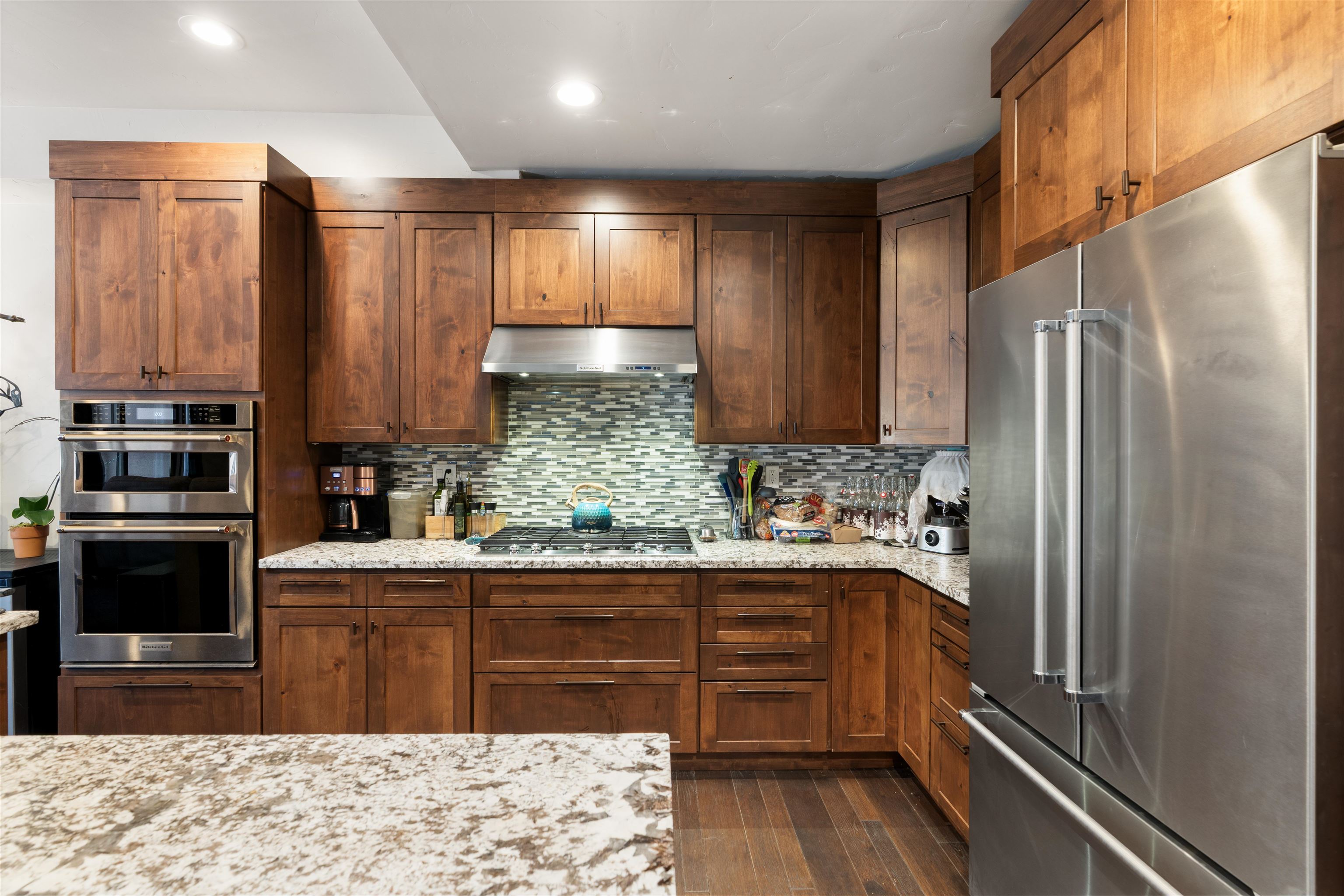 10237 Annies Loop, Unit A5 Truckee, CA 96161 - Photo 2 of 11 a kitchen with stainless steel appliances kitchen island granite countertop a refrigerator and sink