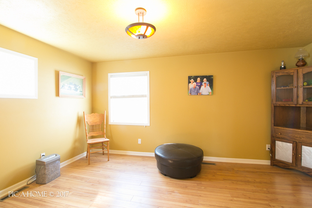 15063 Shabbona Road Malta, IL 60150 - Photo 11 of 25 a view of a room with wooden floor and furniture