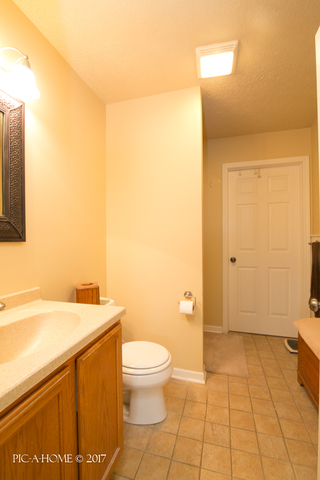15063 Shabbona Road Malta, IL 60150 - Photo 12 of 25 a bathroom with a sink a toilet and shower