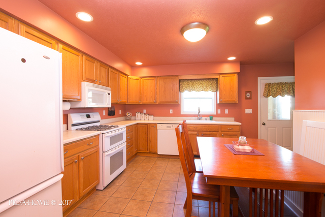 15063 Shabbona Road Malta, IL 60150 - Photo 3 of 25 a large kitchen with a large window and stainless steel appliances