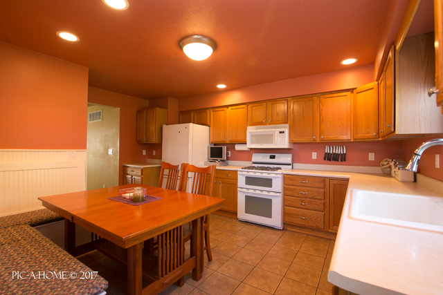 15063 Shabbona Road Malta, IL 60150 - Photo 4 of 25 a kitchen with cabinets and chairs