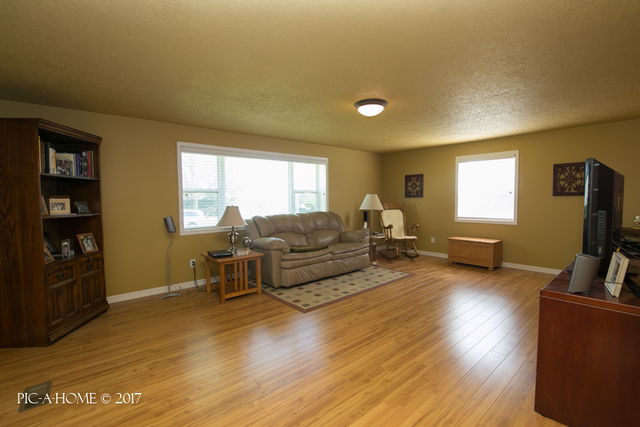 15063 Shabbona Road Malta, IL 60150 - Photo 8 of 25 a living room with furniture a flat screen tv and wooden floor