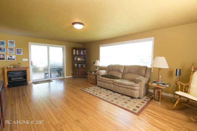 15063 Shabbona Road Malta, IL 60150 - Photo 9 of 25 a living room with furniture and a wooden floor