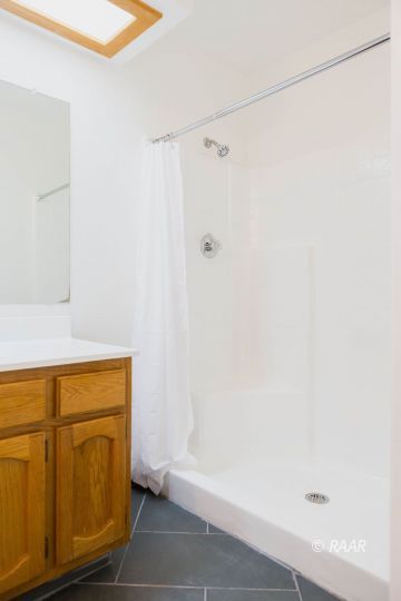 432 Ashton Street Ridgecrest, CA 93555 - Photo 18 of 31 a bathroom with a shower and a sink