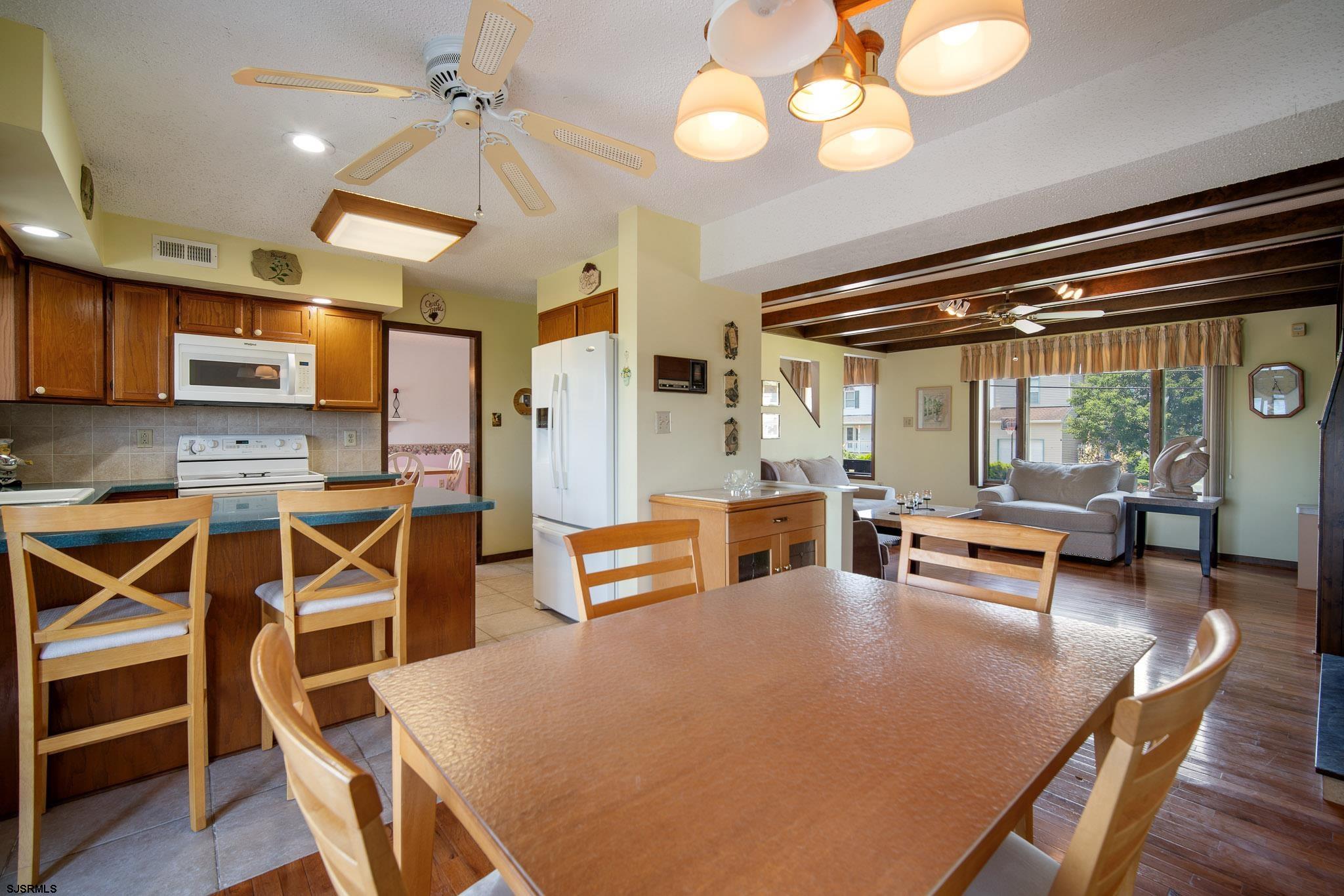 217 Hagen Road Brigantine, NJ 08203 - Photo 29 of 63 a living room with furniture a flat screen tv and a large window