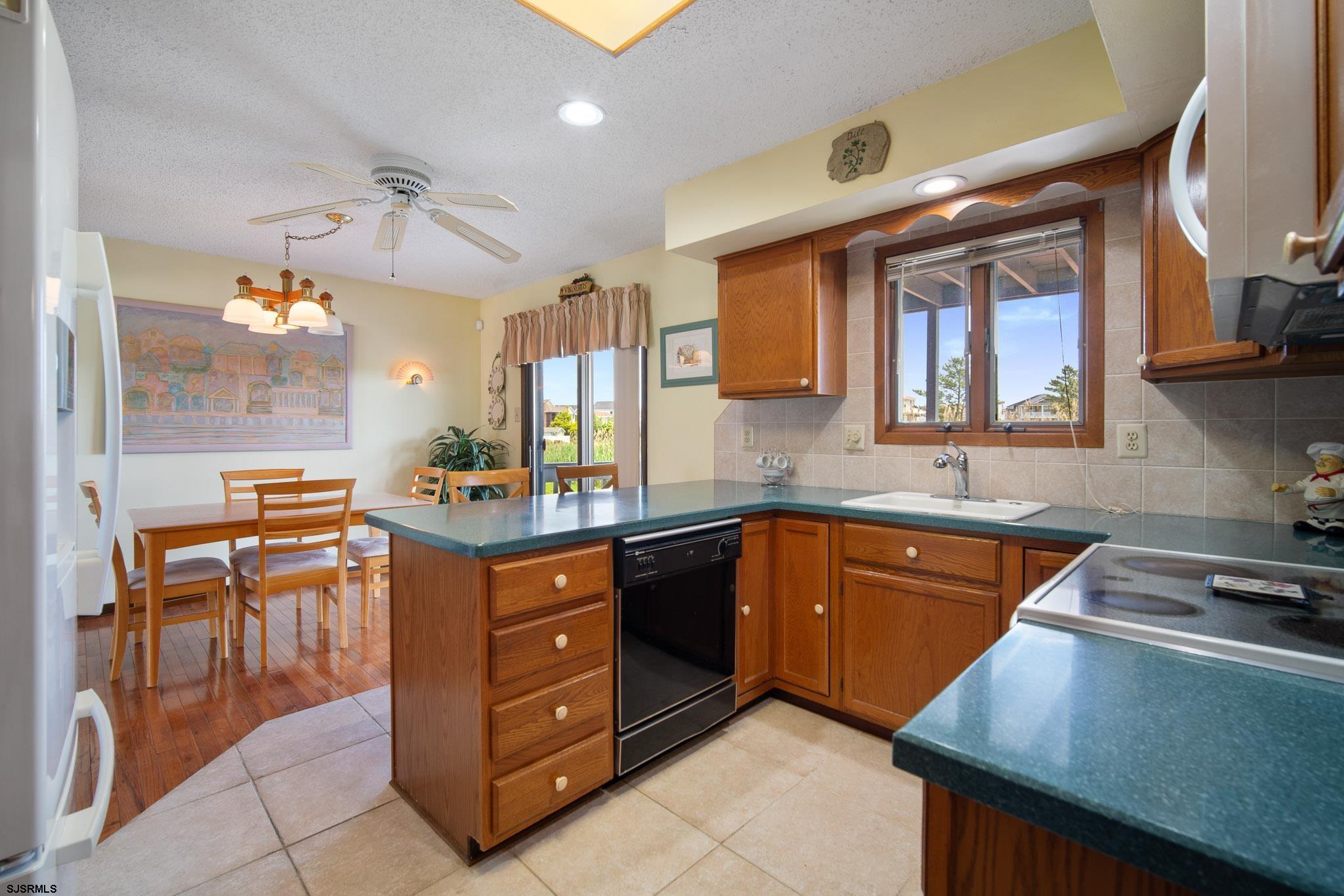 217 Hagen Road Brigantine, NJ 08203 - Photo 32 of 63 a kitchen with a stove a sink and a refrigerator
