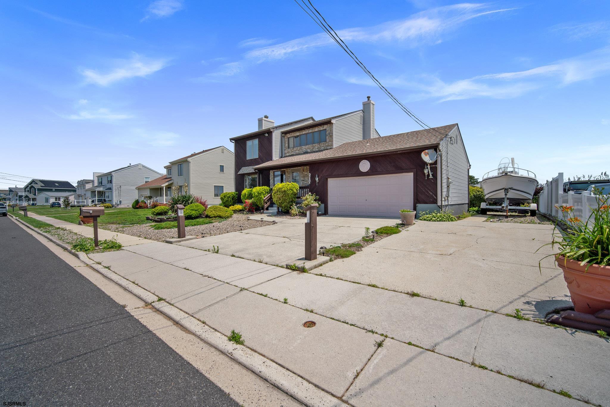 217 Hagen Road Brigantine, NJ 08203 - Photo 48 of 63 a front view of a house with a yard and trees
