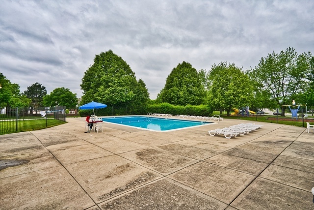 Undisclosed Address Schaumburg, IL 60193 - Photo 14 of 17 a view of a swimming pool with a yard
