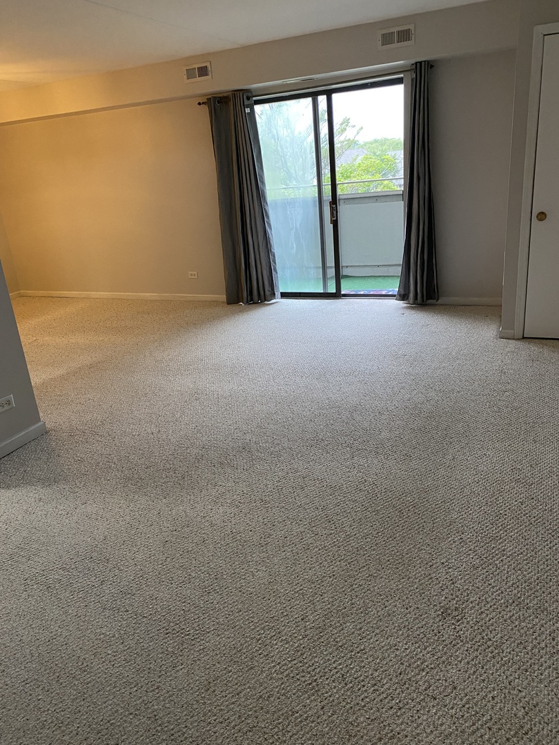 Undisclosed Address Schaumburg, IL 60193 - Photo 6 of 17 a view of large empty room with a large window