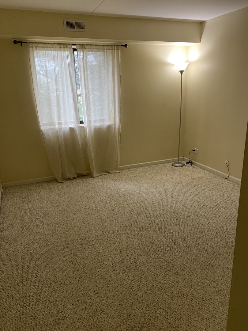 Undisclosed Address Schaumburg, IL 60193 - Photo 7 of 17 a view of an empty room with a window