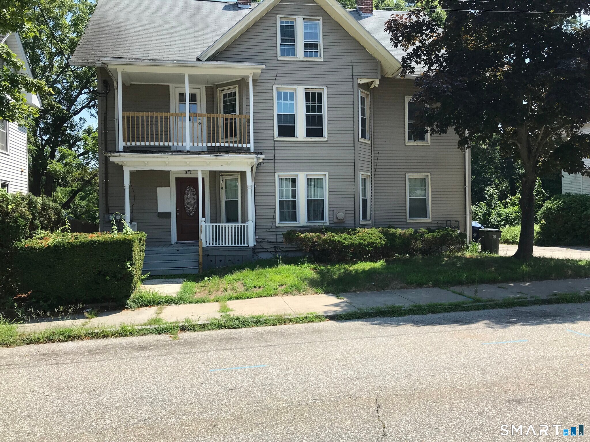 a front view of a house with a garden and plants