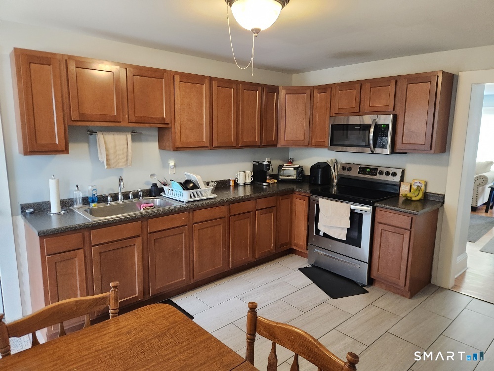 249 Church Street Windham, CT 06226 - Photo 5 of 10 a kitchen with a sink stove and microwave
