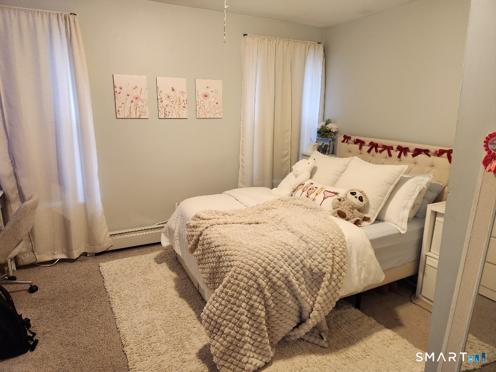 249 Church Street Windham, CT 06226 - Photo 7 of 10 a bed sitting in a bedroom next to a window