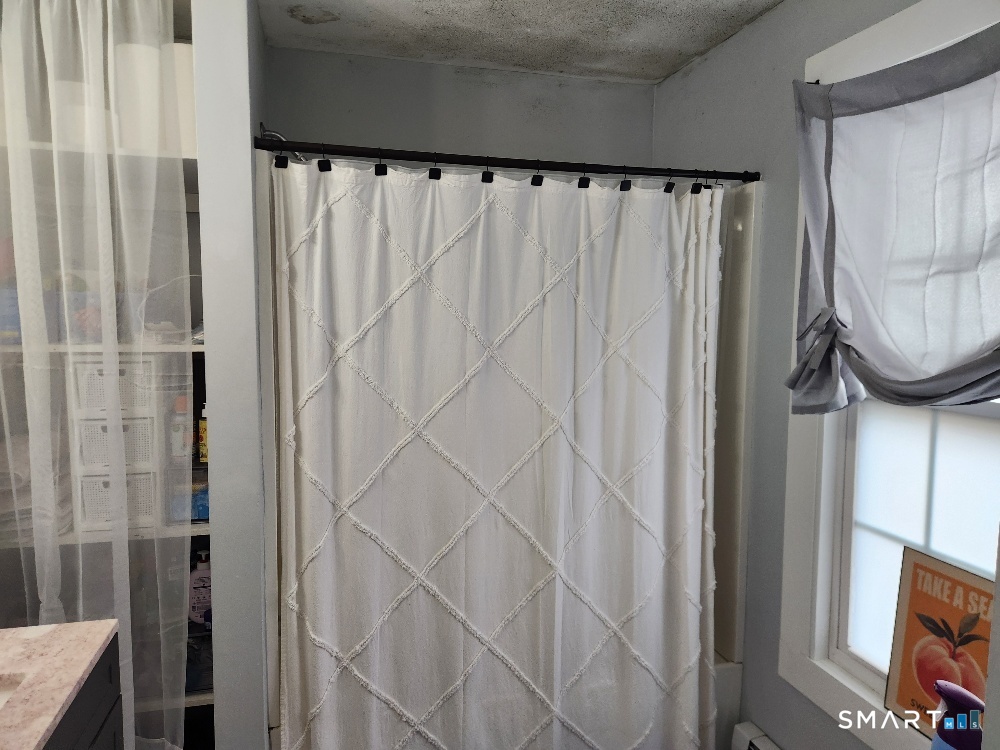 249 Church Street Windham, CT 06226 - Photo 10 of 10 a bathroom with a shower curtain and a mirror