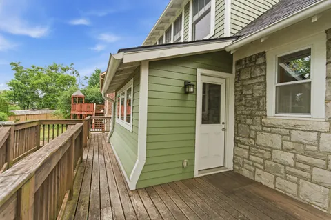 a view of a balcony with wooden floor and fence